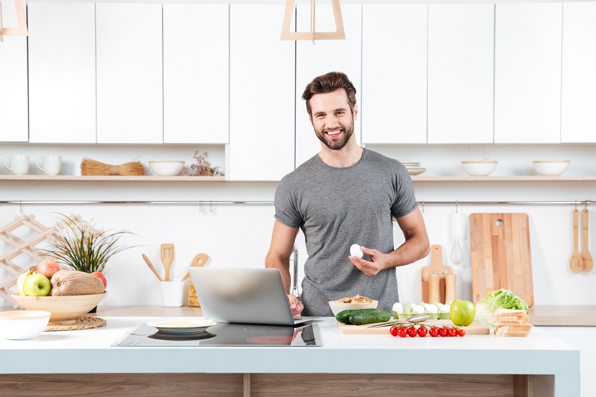 fit man preparing a meal in a kitchen
