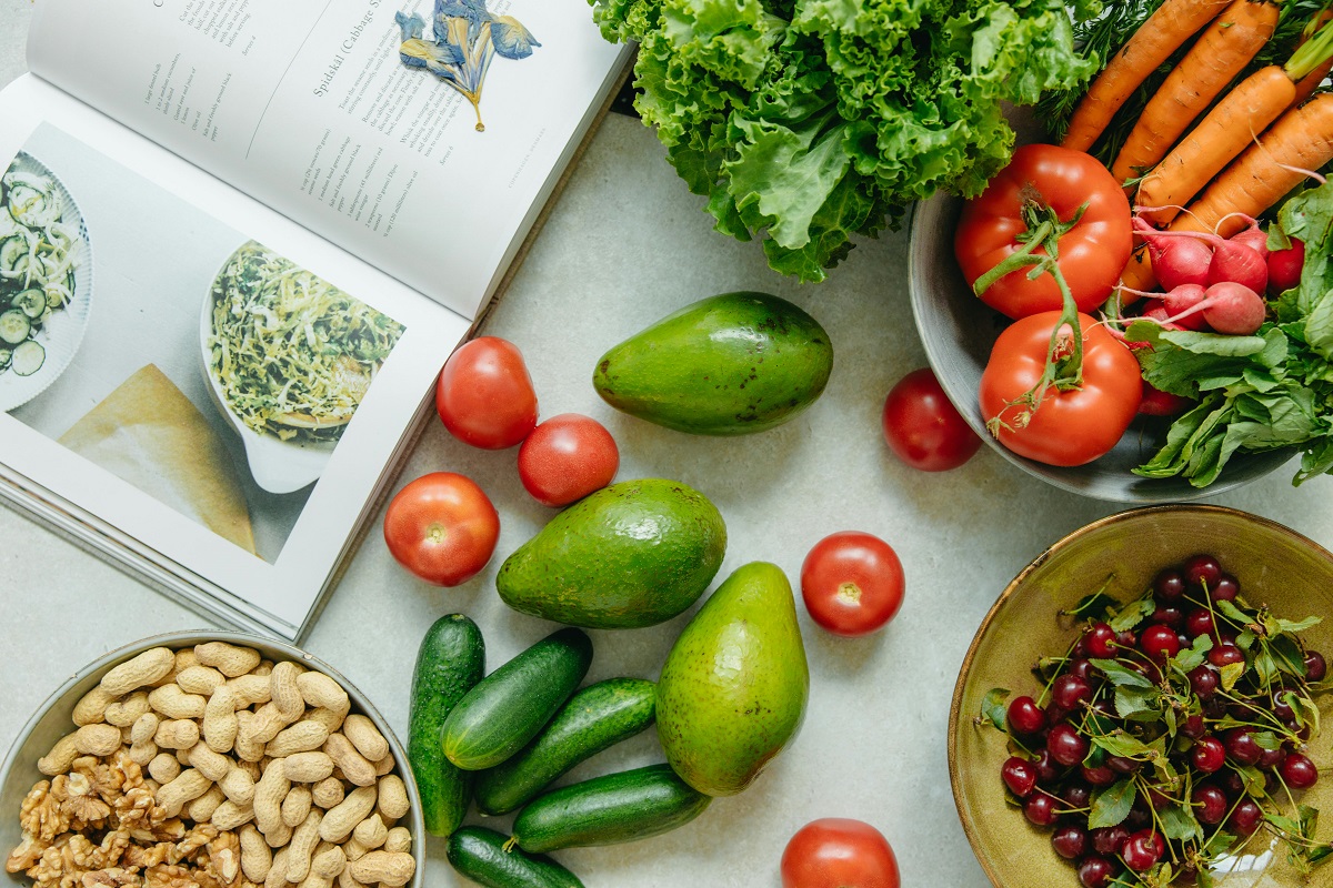 avocado, cucumbers, tomatoes, and nuts on a table